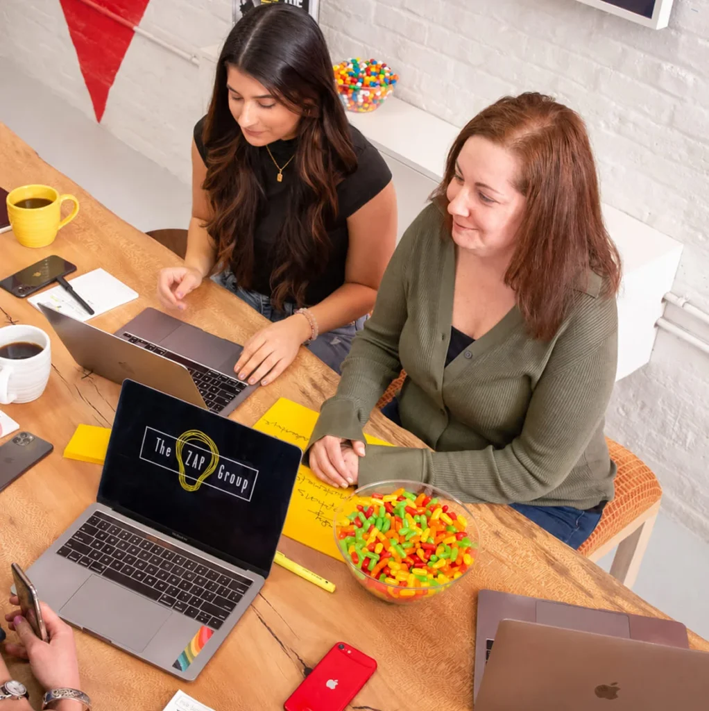 The ZAP Group team collaborating around an office table