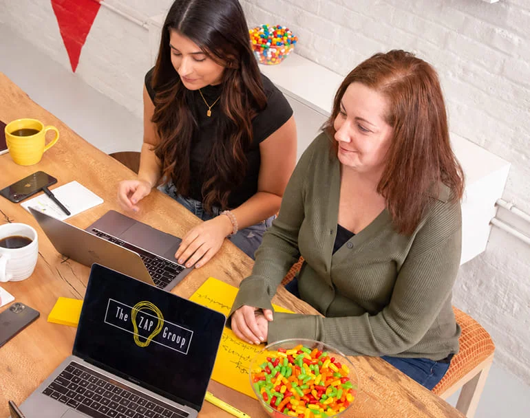 The ZAP Group team collaborating around an office table