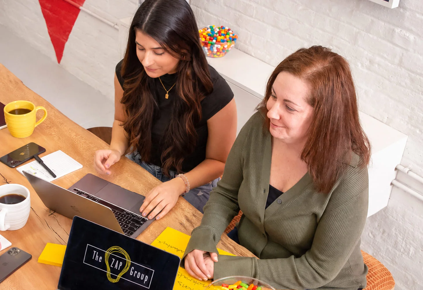 The ZAP Group team collaborating around an office table